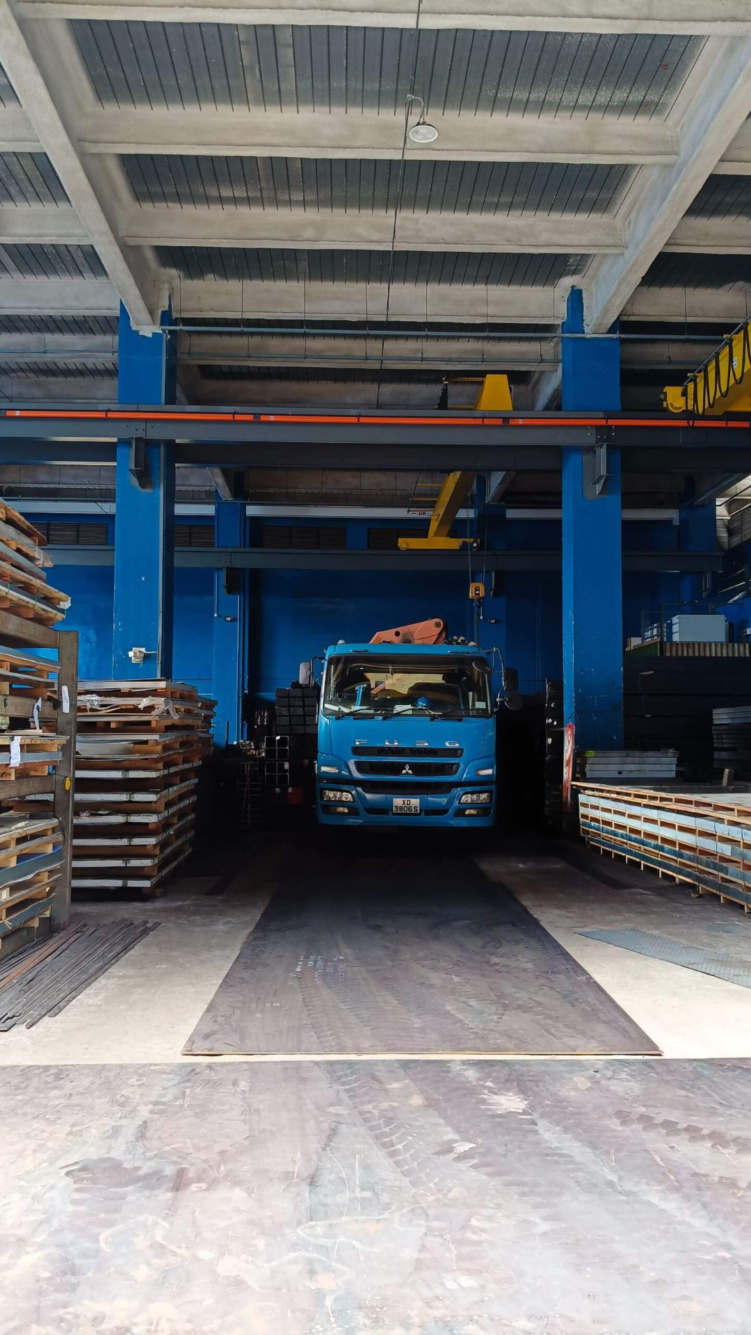 Delivery truck loading steel plate at the warehouse bay