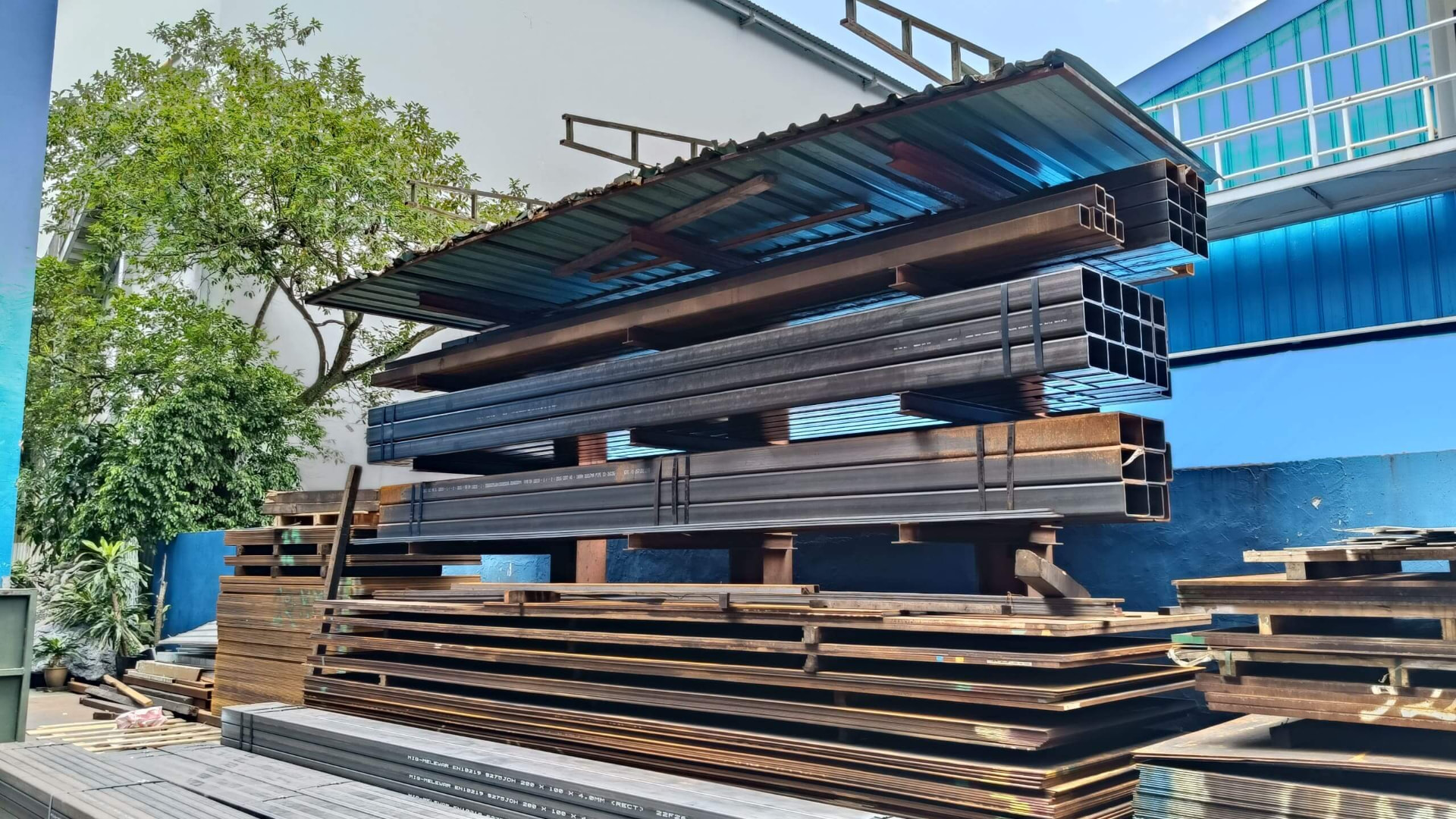 Stacked steel beams, plates and tubes in the yard